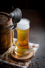 Light beer in a glass, on an old background.