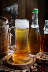 Light beer in a glass, on an old background.