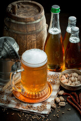 Light beer in a glass, on an old background.
