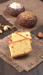 Slices of home made wholemeal bread on a white background with wheat and flour.
