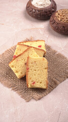 Slices of home made wholemeal bread on a white background with wheat and flour.