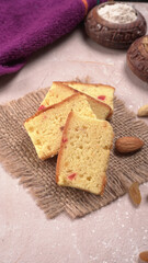 Slices of home made wholemeal bread on a white background with wheat and flour.