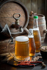 Light beer in a glass, on an old background.