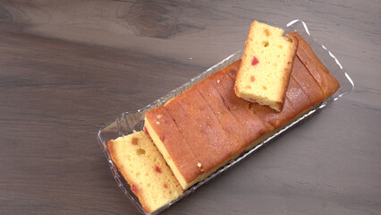 Slices of home made wholemeal bread on a white background with wheat and flour.