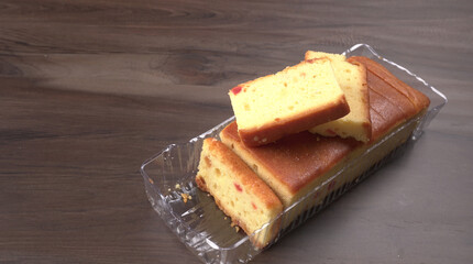 Slices of home made wholemeal bread on a white background with wheat and flour.