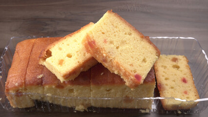 Slices of home made wholemeal bread on a white background with wheat and flour.