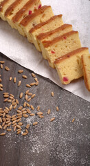 Slices of home made wholemeal bread on a white background with wheat and flour.