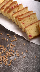 Slices of home made wholemeal bread on a white background with wheat and flour.