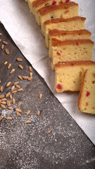 Slices of home made wholemeal bread on a white background with wheat and flour.