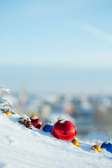 Toys and gifts from Santa in the snow, in the forest with a view of the village, in bright and sunny weather.