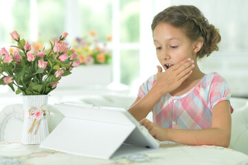 Portrait of  Beautiful little  girl with tablet pc