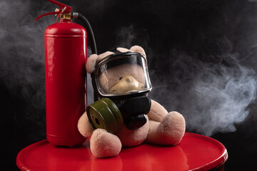 the mascot of the fire brigade is a teddy bear in a gas mask with a fire extinguisher in smoke on a...