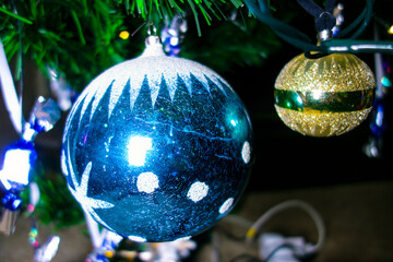 The Christmas glass ornament sways and glitters on the Christmas