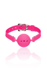 Detailed shot of a mouth gag made as a pink silicone ball with breathing holes on a pink leather belt. The accessory for erotic games is located on the white backdrop. Front view.