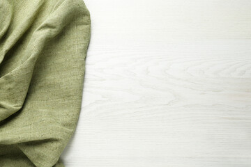 Natural burlap fabric on white wooden table, top view. Space for text