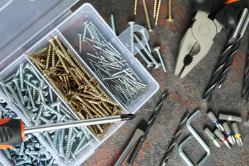 Fototapeta premium Work tools on dark textured background, top view