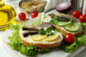 Concept of tasty snack with sandwiches with sprats, close up