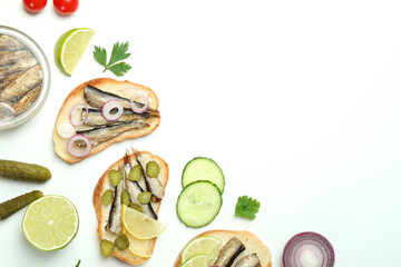Concept of tasty snack with sandwiches with sprats on white background