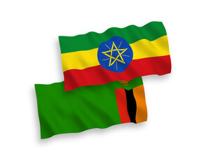 National vector fabric wave flags of Republic of Zambia and Ethiopia isolated on white background. 1 to 2 proportion.