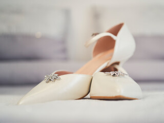 White wedding shoes with brooch