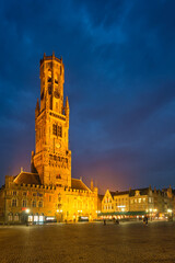 Naklejka premium Belfry tower and Grote markt square in Bruges, Belgium on dusk in twilight