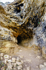 Entrance into the cave carved into the rock of the Duraton river park mountain, Segovia.