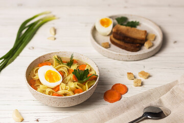 noodle soup with eggs and bread