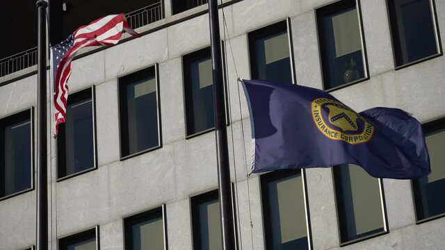 Flags in front of Federal Deposit Insurance Corporation building in Washington, DC.