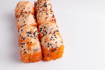 a portion of rolls on a stand, japanese food, sushi on the table, chinese chopsticks, light background