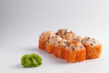 a portion of rolls on a stand, japanese food, sushi on the table, chinese chopsticks, light background