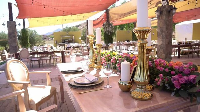 Glasses, flowers and candles on an elegant table.