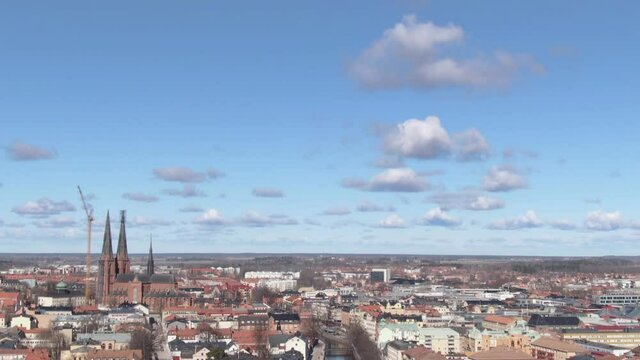 Uppsala city skyline with cathedral in Sweden. Aerial view tilting down