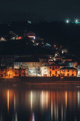 Fototapeta premium A village near water photographed at night in Portugal