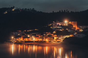 Naklejka premium A village near water photographed at night in Portugal