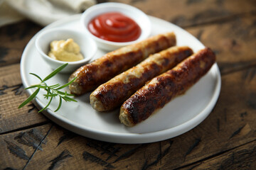 Homemade roasted sausages with ketchup and mustard	