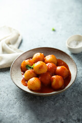 Traditional homemade dumplings with tomato sauce