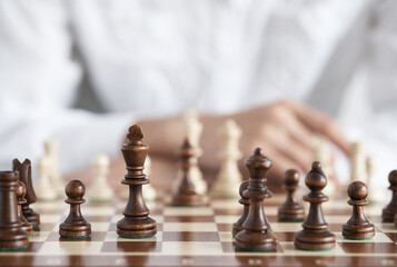 Chess pieces close up. The chess player sits on the opposite side of the opponent. Chess game....