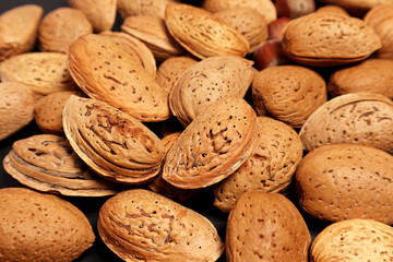 Almond nuts background. Almond with shell. Selective focus.