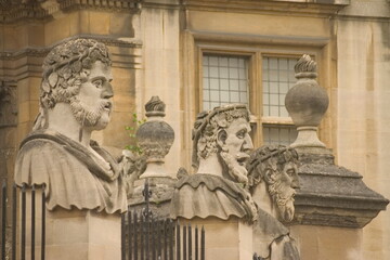 Carved emperor or philosopher heads around the perimeter of the Sheldonian Theatre in Oxford England