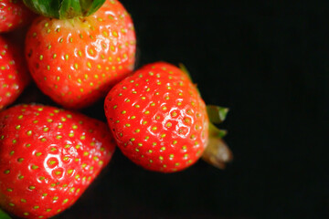 Selective focus of beautiful strawberries isolated on black background