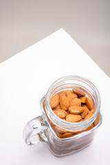Glass jar filled with a variety of nutrition and healthy snacks and nuts on a dark background