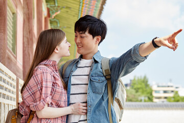 A young couple of a Western woman and a Korean man on a date while relaxing in a traditional Korean...
