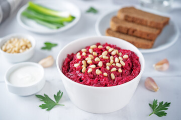 Beetroot salad with pine nuts in a bowl