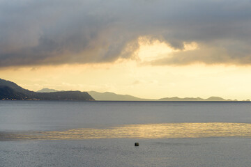 Panorama shots of gorgeous sunset over the Pacific Ocean with puffy rain clouds in the background. 