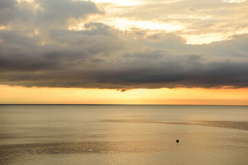 Panorama shots of gorgeous sunset over the Pacific Ocean with puffy rain clouds in the background. 