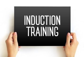 Induction Training text on card, concept background
