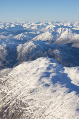 Obraz premium Aerial View from an Airplane of Whistler Mountain covered in fresh snow during winter season. British Columbia, Canada. Canadian Nature Landscape Background