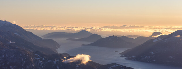Aerial Panoramic View of Howe Sound, Islands and Canadian Mountain Landscape on the West Coast of Pacific Ocean. Located near Squamish and Vancouver, British Columbia, Canada. Winter Sunset - obrazy, fototapety, plakaty