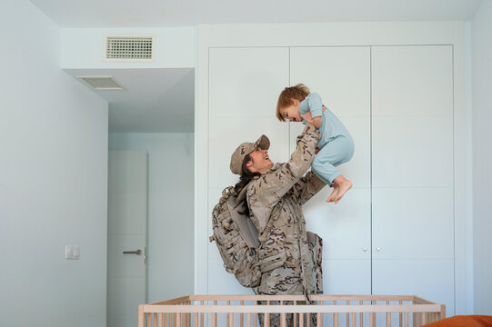 Caring military woman holding son