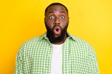 Photo of astonished young guy open mouth stupor confused look camera isolated on yellow color background